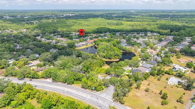 aerial view featuring a residential view, a view of trees, and a water view