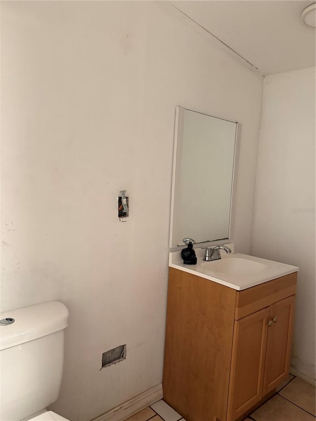 bathroom featuring vanity, toilet, and tile patterned flooring
