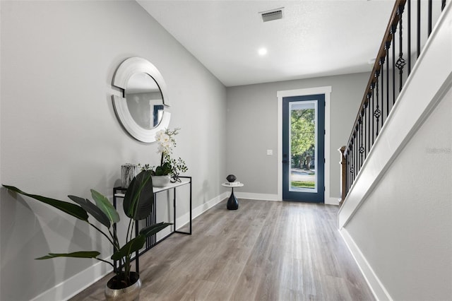 116 W Stanley St, Tampa, FL 33604 - foyer entrance featuring baseboards, wood finished floors, and stairway