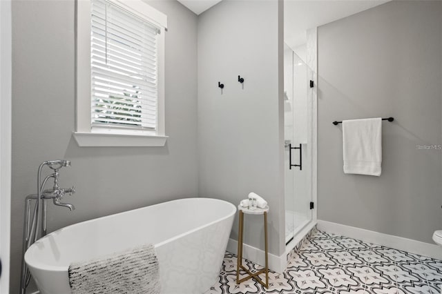 116 W Stanley St, Tampa, FL 33604 - full bath featuring baseboards, a stall shower, a freestanding bath, and tile patterned floors