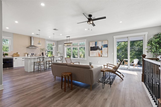 116 W Stanley St, Tampa, FL 33604 - living room with beverage cooler, light wood-style flooring, recessed lighting, a ceiling fan, and baseboards