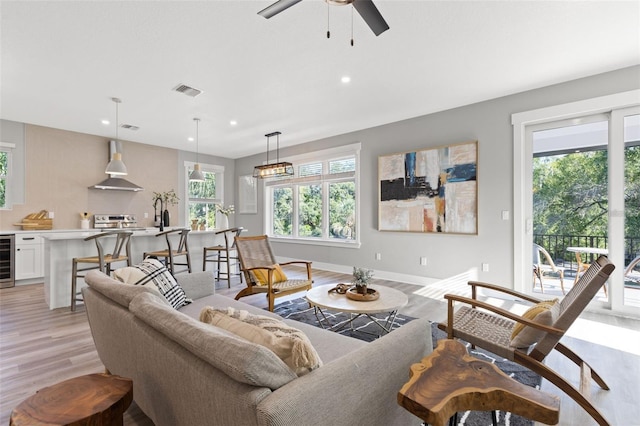 116 W Stanley St, Tampa, FL 33604 - living room with light wood-style flooring, beverage cooler, a ceiling fan, recessed lighting, and baseboards