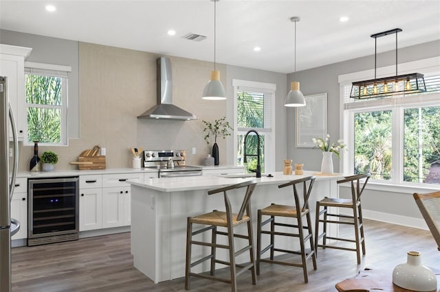 116 W Stanley St, Tampa, FL 33604 - kitchen with beverage cooler, wall chimney exhaust hood, appliances with stainless steel finishes, a sink, and tasteful backsplash