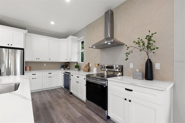 116 W Stanley St, Tampa, FL 33604 - kitchen featuring stainless steel appliances, beverage cooler, wall chimney range hood, wood finished floors, and white cabinets