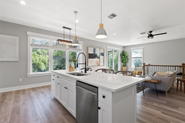 116 W Stanley St, Tampa, FL 33604 - kitchen with dishwasher, a sink, wood finished floors, white cabinets, and hanging light fixtures