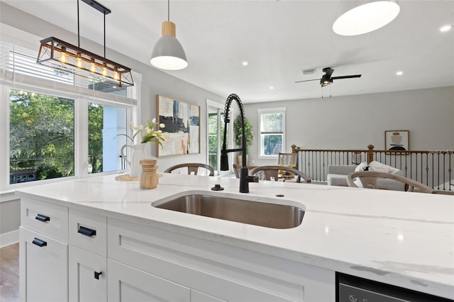 116 W Stanley St, Tampa, FL 33604 - kitchen with a sink, light stone counters, white cabinets, decorative light fixtures, and recessed lighting