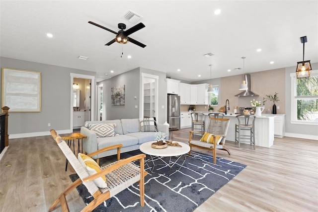 116 W Stanley St, Tampa, FL 33604 - living room featuring light wood-style flooring, recessed lighting, baseboards, and a ceiling fan