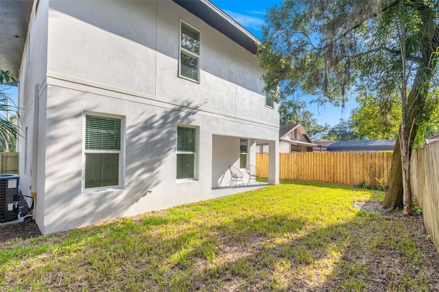 116 W Stanley St, Tampa, FL 33604 - rear view of house featuring a patio area, central AC, and stucco siding