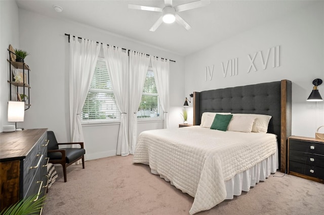 bedroom with a ceiling fan, baseboards, and light colored carpet