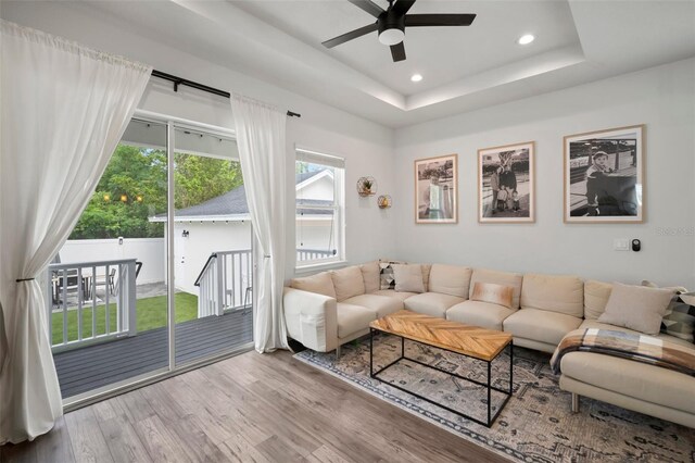 living room with recessed lighting, a ceiling fan, wood finished floors, and a wealth of natural light