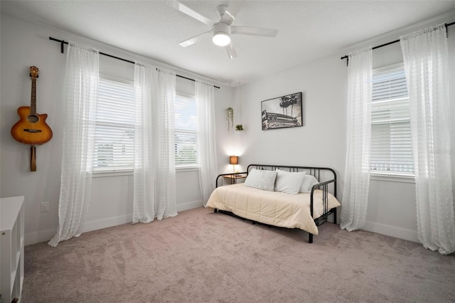 bedroom with baseboards, ceiling fan, and carpet flooring