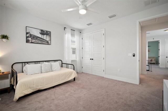 bedroom with carpet, attic access, and visible vents