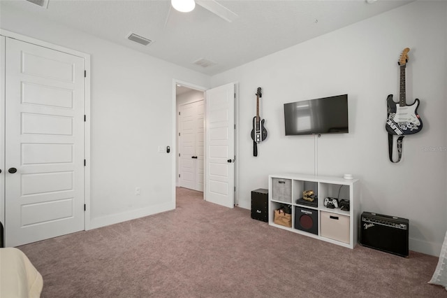 interior space with a ceiling fan, baseboards, visible vents, and carpet