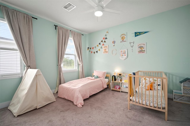 bedroom featuring carpet flooring, a ceiling fan, and visible vents