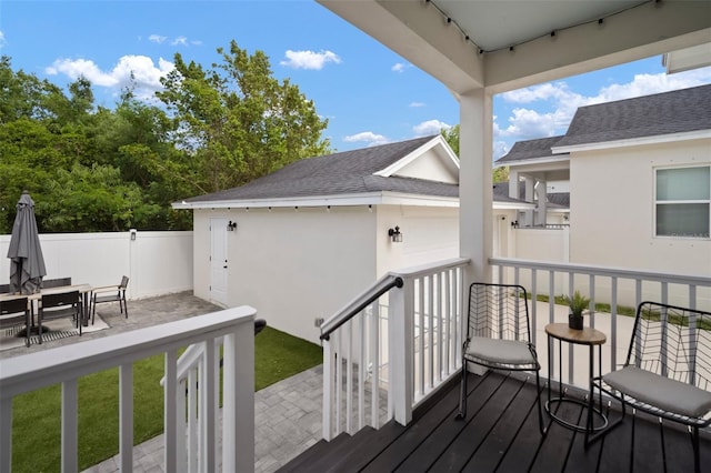 wooden terrace featuring fence