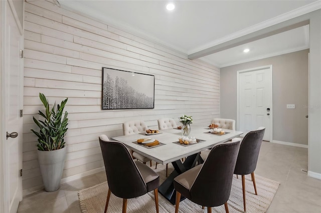 dining space featuring crown molding, light tile patterned floors, baseboards, wooden walls, and recessed lighting