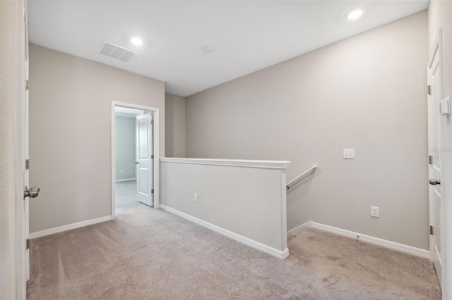 carpeted empty room featuring recessed lighting, baseboards, and visible vents