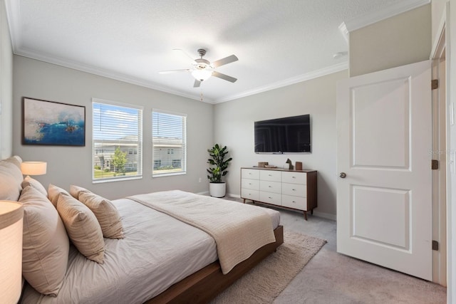 bedroom featuring a ceiling fan, baseboards, light carpet, and ornamental molding