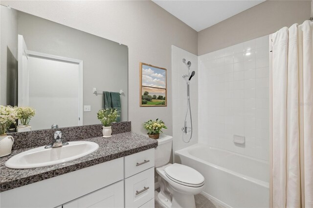 bathroom featuring vanity, toilet, and shower / tub combo