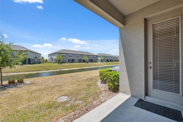 31970 Blue Passing Loop, Wesley Chapel, FL 33545 - view of green lawn featuring a residential view and a water view