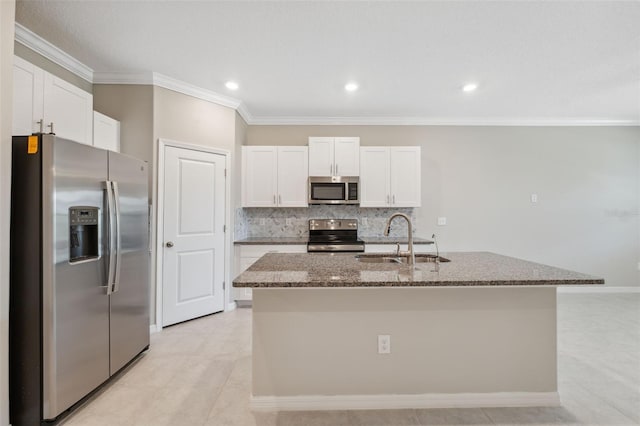 31970 Blue Passing Loop, Wesley Chapel, FL 33545 - kitchen with appliances with stainless steel finishes, a sink, white cabinets, dark stone countertops, and ornamental molding