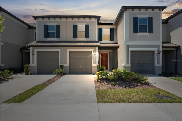 31970 Blue Passing Loop, Wesley Chapel, FL 33545 - view of property with stucco siding, an attached garage, and driveway