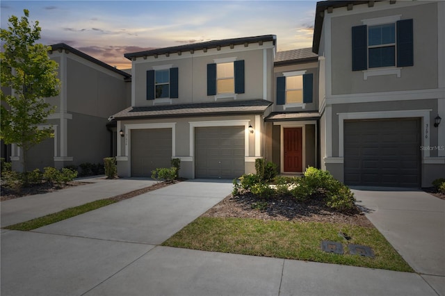 31970 Blue Passing Loop, Wesley Chapel, FL 33545 - view of front of house featuring stucco siding, a garage, and driveway