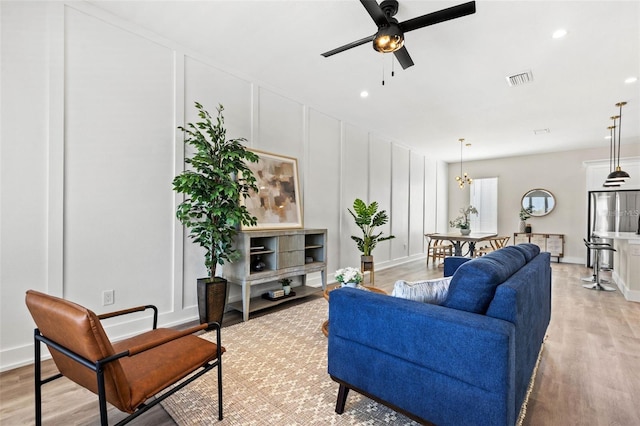 121 E Warren Ave Unit 1, Tampa, FL 33602 - living area with a decorative wall, light wood-style flooring, a ceiling fan, and recessed lighting