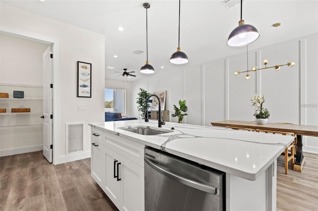 121 E Warren Ave Unit 1, Tampa, FL 33602 - kitchen featuring stainless steel dishwasher, a sink, light wood-type flooring, a kitchen island with sink, and recessed lighting