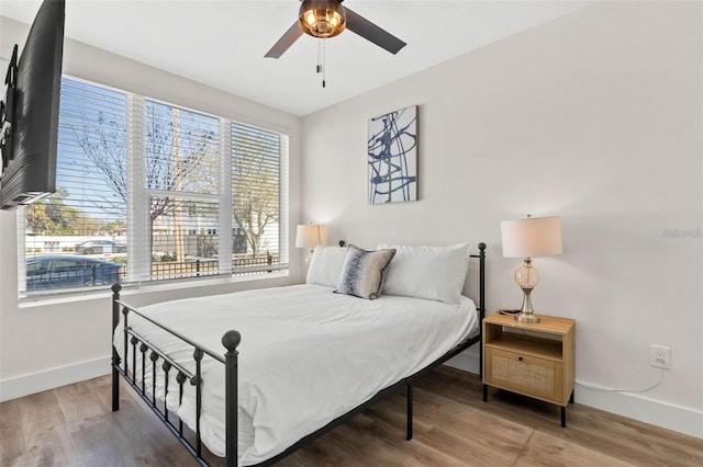 121 E Warren Ave Unit 1, Tampa, FL 33602 - bedroom with baseboards, wood finished floors, and ceiling fan