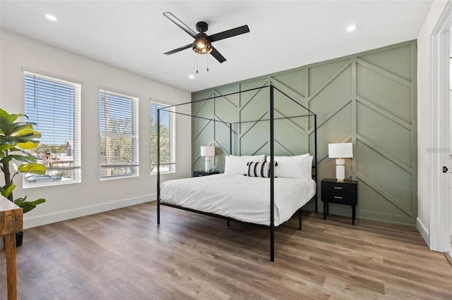 121 E Warren Ave Unit 1, Tampa, FL 33602 - bedroom featuring baseboards, wood finished floors, recessed lighting, a decorative wall, and ceiling fan