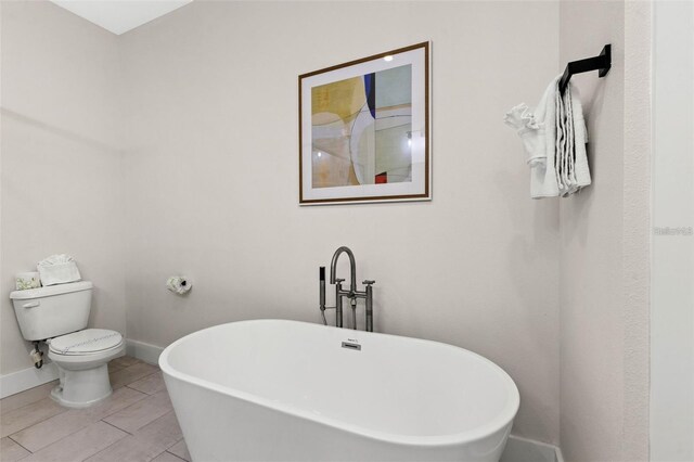 121 E Warren Ave Unit 1, Tampa, FL 33602 - full bath with a soaking tub, baseboards, and toilet