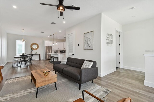 121 E Warren Ave Unit 1, Tampa, FL 33602 - living room featuring a ceiling fan, light wood-type flooring, and recessed lighting