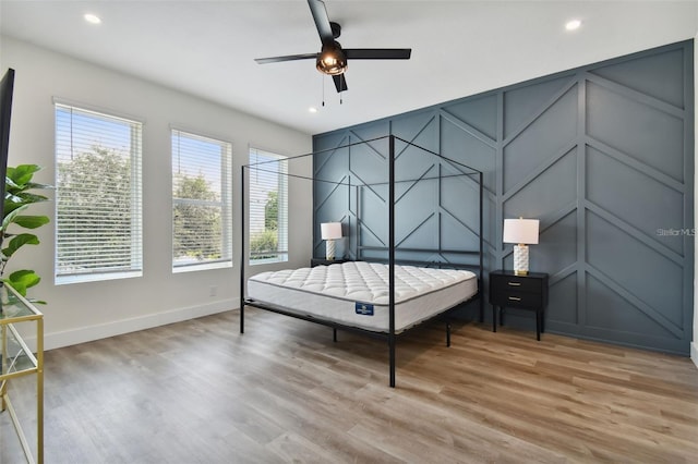121 E Warren Ave Unit 1, Tampa, FL 33602 - bedroom with a decorative wall, light wood-style floors, recessed lighting, and a ceiling fan