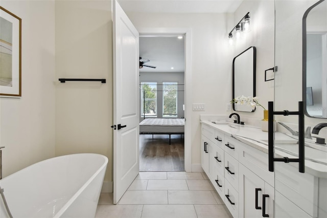 121 E Warren Ave Unit 1, Tampa, FL 33602 - ensuite bathroom with ceiling fan, double vanity, a freestanding tub, and tile patterned flooring