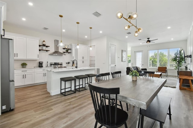 121 E Warren Ave Unit 1, Tampa, FL 33602 - dining room with ceiling fan, light wood finished floors, recessed lighting, and a chandelier