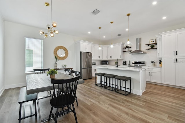 121 E Warren Ave Unit 1, Tampa, FL 33602 - dining space featuring recessed lighting, light wood-style flooring, and a chandelier