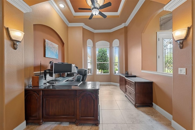 office space with a ceiling fan, arched walkways, baseboards, ornamental molding, and light tile patterned flooring