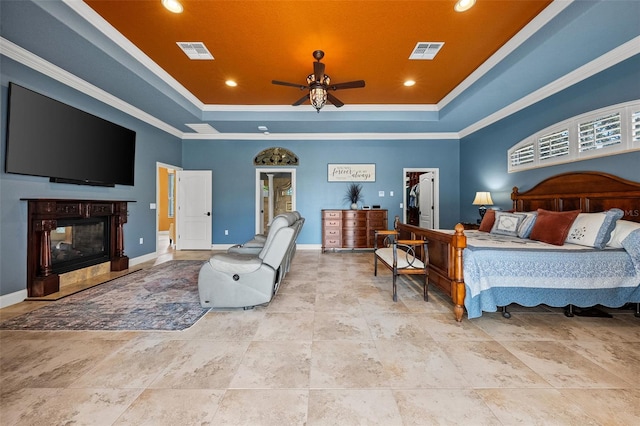 bedroom with visible vents, ornamental molding, baseboards, and a tray ceiling