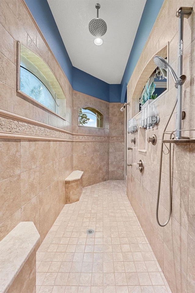 full bath with a tile shower