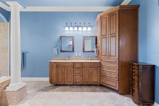 full bathroom featuring double vanity, ornamental molding, decorative columns, and a sink