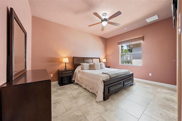bedroom with baseboards, ceiling fan, and a textured ceiling