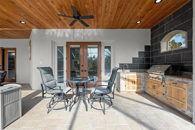 view of patio / terrace featuring ceiling fan, grilling area, exterior kitchen, and french doors