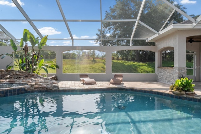 outdoor pool with a patio, ceiling fan, and a lanai