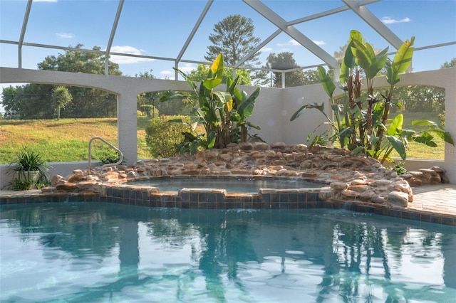 outdoor pool with a lanai and a hot tub