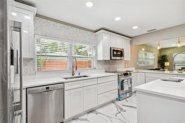 2042 Craft Ln, Sarasota, FL 34239 - kitchen with visible vents, marble finish floor, recessed lighting, a sink, and appliances with stainless steel finishes