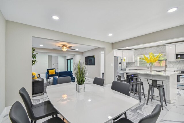 2042 Craft Ln, Sarasota, FL 34239 - dining room with plenty of natural light, a ceiling fan, recessed lighting, and marble finish floor