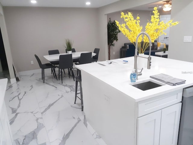 2042 Craft Ln, Sarasota, FL 34239 - kitchen featuring marble finish floor, recessed lighting, light countertops, white cabinets, and a sink