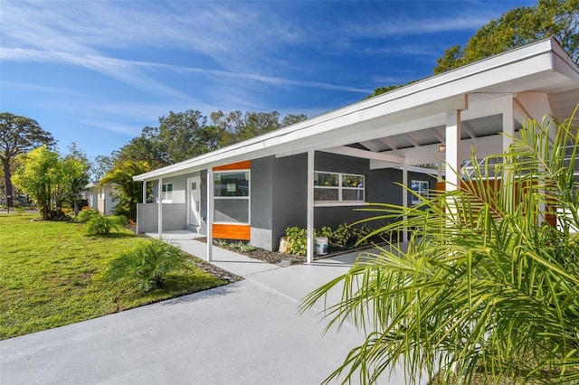 2042 Craft Ln, Sarasota, FL 34239 - view of front of home with a front lawn and stucco siding