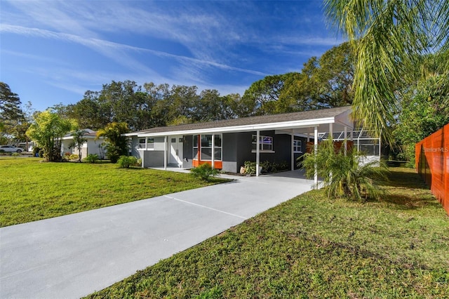 2042 Craft Ln, Sarasota, FL 34239 - back of property with a yard, an attached carport, and concrete driveway